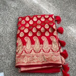 Red saree in georgette chiffon material with golden paisley embroidery